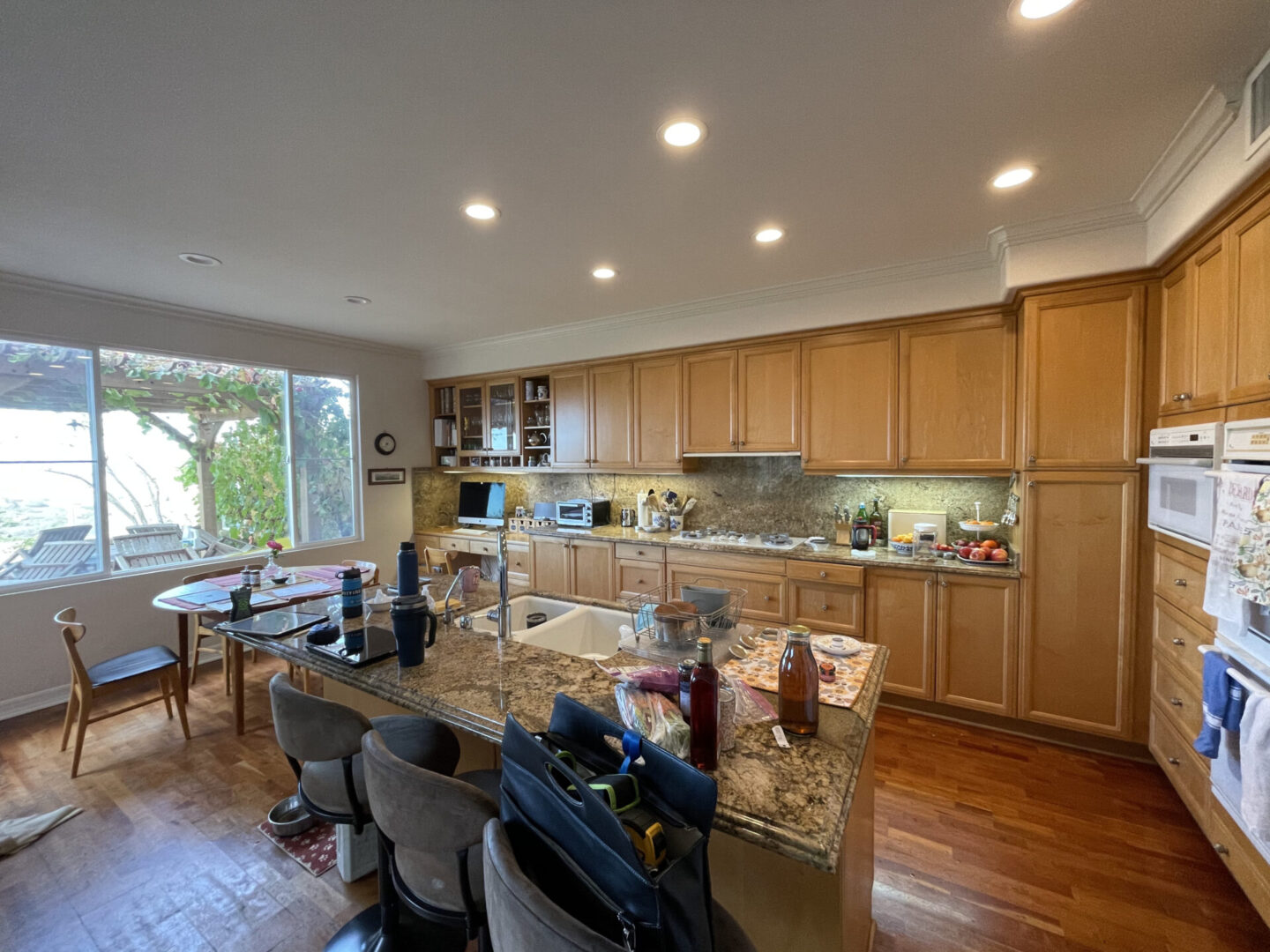 A beautiful kitchen area with so many chairs and table